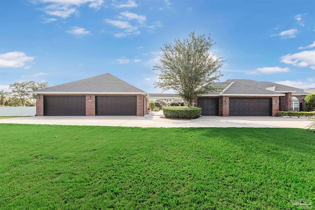 ranch-style home featuring a garage and a front lawn