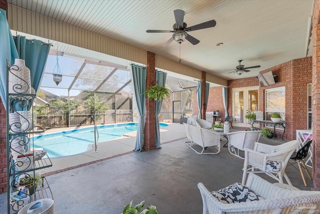 view of swimming pool with a fenced in pool, a patio, a ceiling fan, glass enclosure, and a mountain view