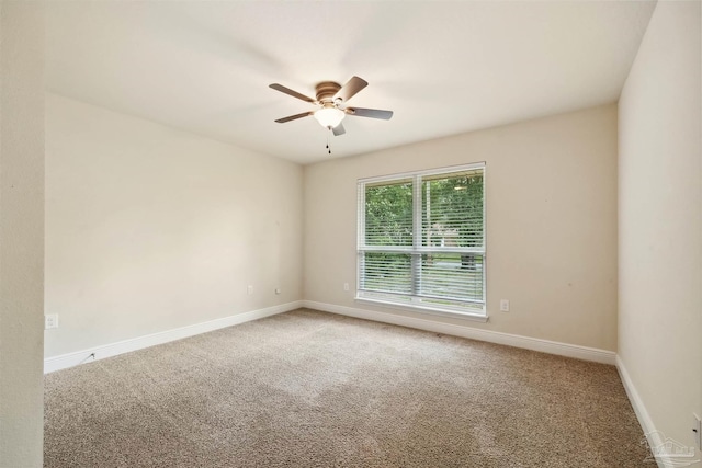 empty room featuring light carpet, ceiling fan, and baseboards