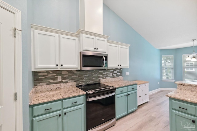 kitchen with tasteful backsplash, hanging light fixtures, appliances with stainless steel finishes, light wood-type flooring, and green cabinetry