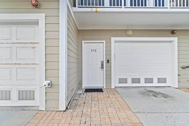 doorway to property featuring a garage