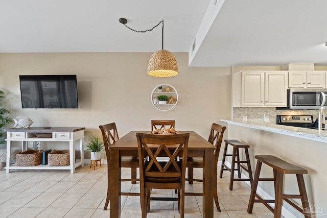 dining area featuring light tile patterned floors