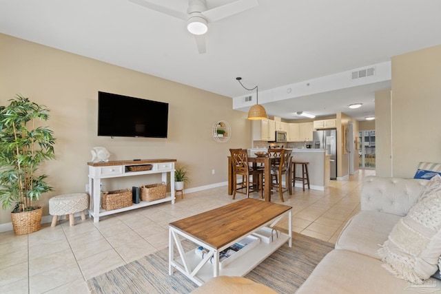 living room featuring ceiling fan and light tile patterned floors