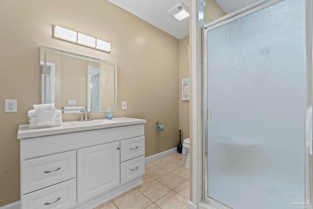 bathroom with toilet, vanity, tile patterned floors, and a shower with shower door