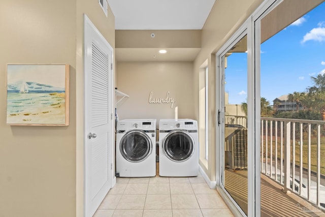 laundry area with light tile patterned floors and independent washer and dryer