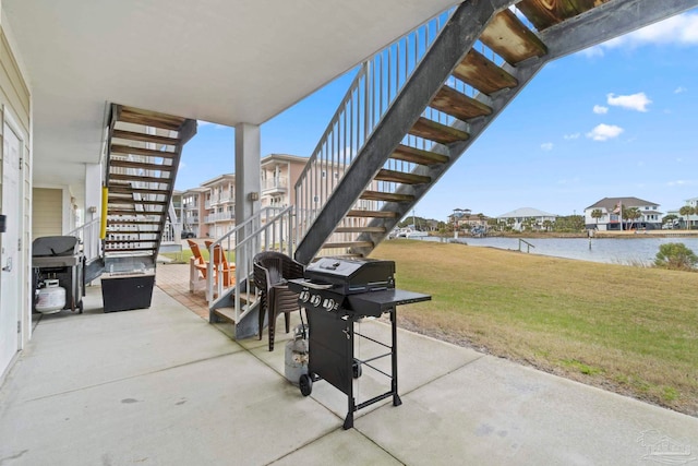 view of patio featuring a grill and a water view