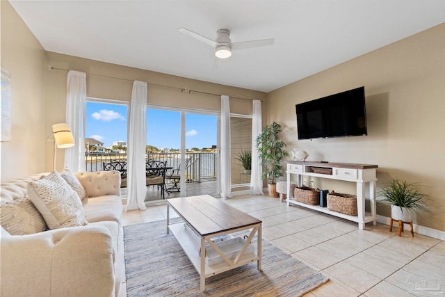 living room featuring ceiling fan and light tile patterned floors