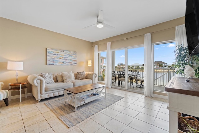 tiled living room with ceiling fan and a healthy amount of sunlight