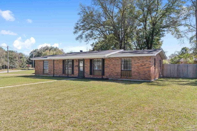 single story home featuring brick siding, a front yard, and fence