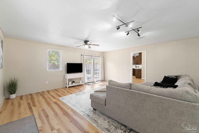 living room with ceiling fan, wood finished floors, and visible vents