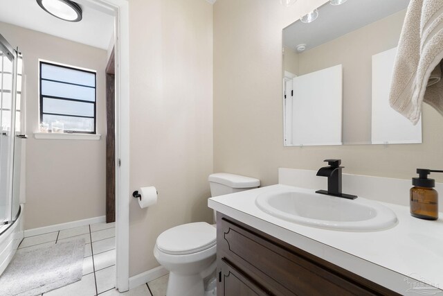 full bathroom with toilet, tile patterned flooring, baseboards, and vanity