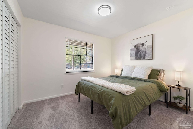 bedroom with carpet flooring and baseboards