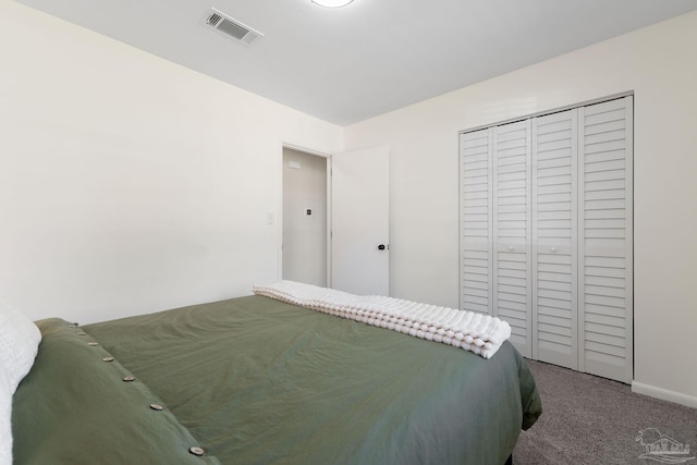 carpeted bedroom featuring a closet and visible vents