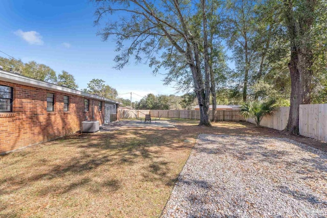 view of yard featuring central AC and a fenced backyard