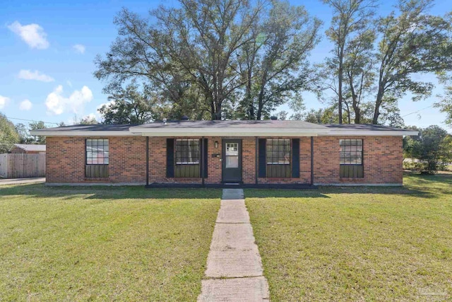 single story home with a front yard, brick siding, and fence