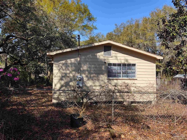 view of home's exterior with fence