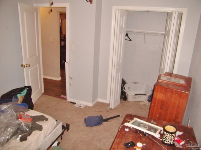 bedroom with light carpet and a closet