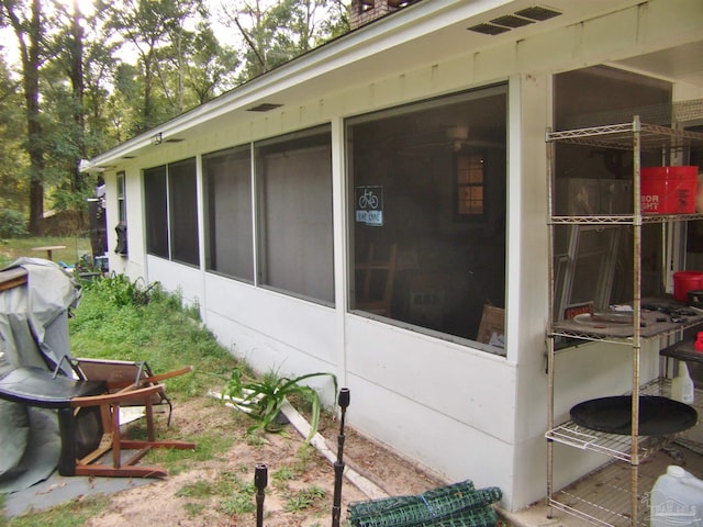 view of side of property featuring a sunroom