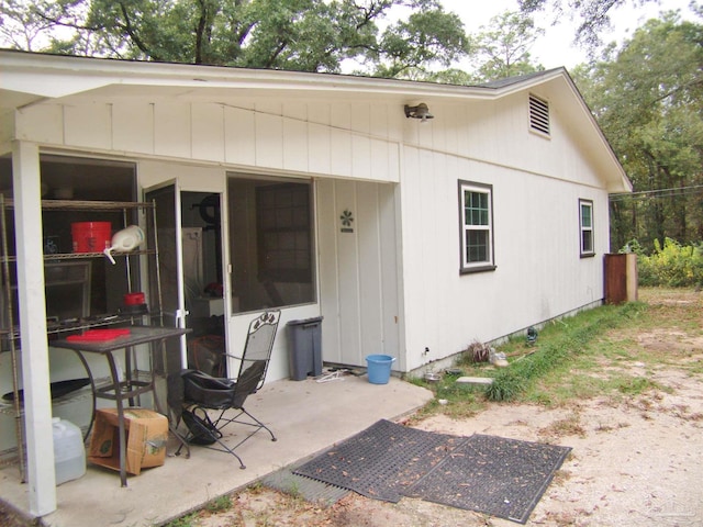 view of exterior entry featuring a patio area