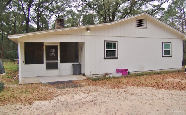 rear view of property with a sunroom