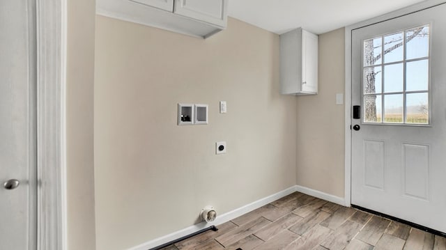 laundry room with washer hookup, electric dryer hookup, a healthy amount of sunlight, and cabinets