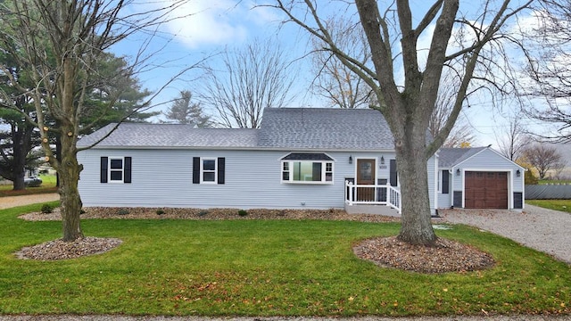 view of front of home featuring a garage and a front lawn