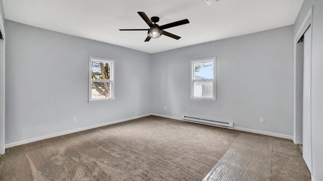 unfurnished bedroom featuring carpet, ceiling fan, and a baseboard heating unit