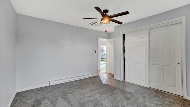 unfurnished bedroom with carpet floors, a closet, a baseboard heating unit, and ceiling fan