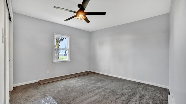 carpeted spare room featuring ceiling fan