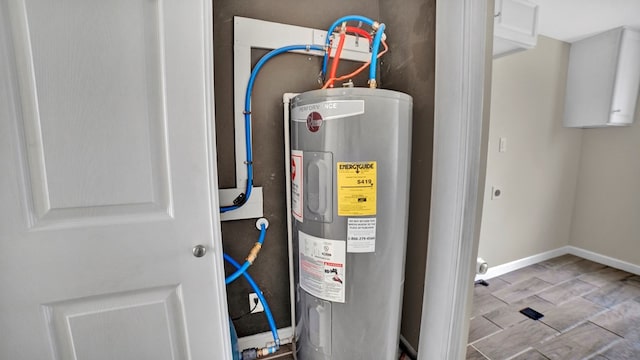 utility room featuring water heater