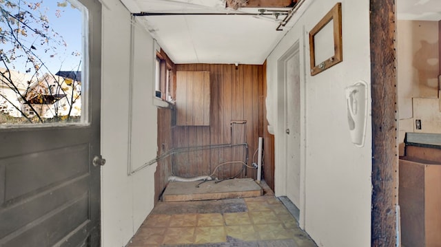 hall featuring wood walls