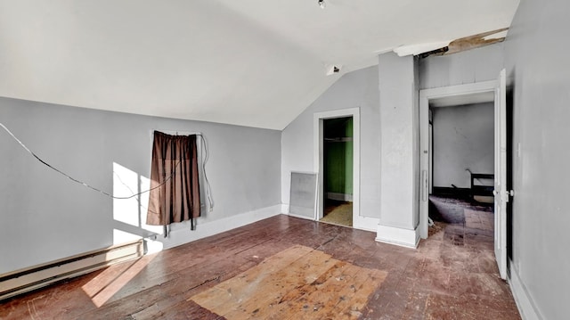 interior space with vaulted ceiling and baseboard heating