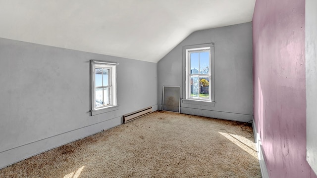 bonus room featuring light colored carpet, vaulted ceiling, and a baseboard heating unit