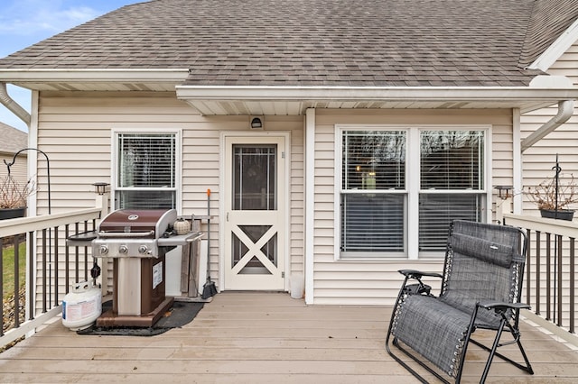 wooden deck with a grill