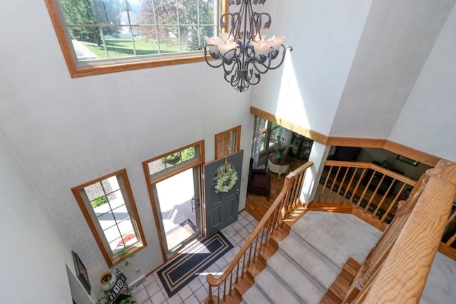 foyer entrance featuring stairway and an inviting chandelier