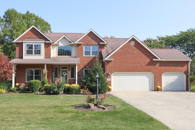 view of front facade with an attached garage, driveway, and a front lawn