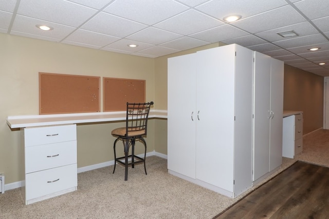 office area with a paneled ceiling and carpet flooring