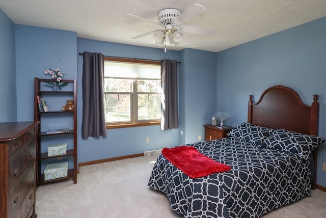 bedroom featuring ceiling fan, carpet, visible vents, and baseboards