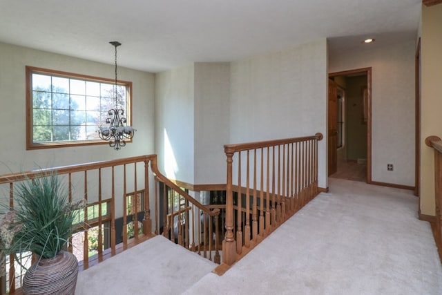 interior space with baseboards, an upstairs landing, carpet floors, a chandelier, and recessed lighting