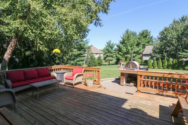 wooden terrace with outdoor lounge area and a lawn