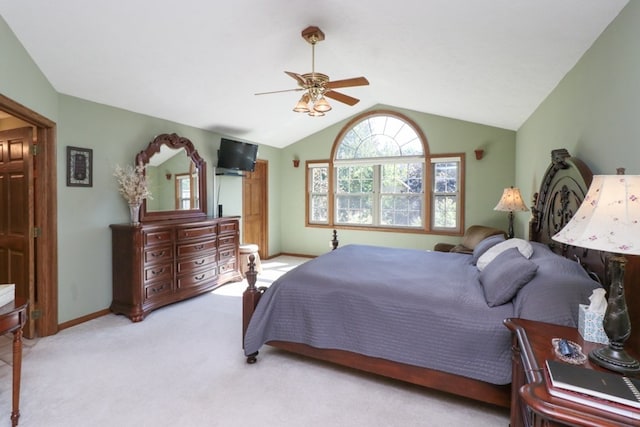 carpeted bedroom featuring lofted ceiling, baseboards, and a ceiling fan