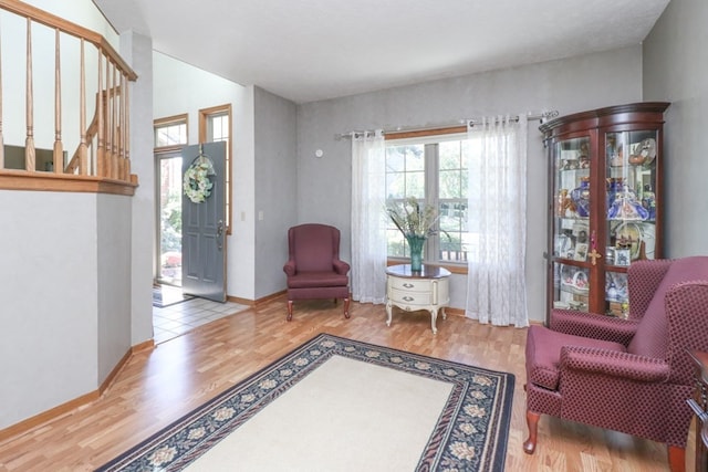 living area with wood finished floors and baseboards