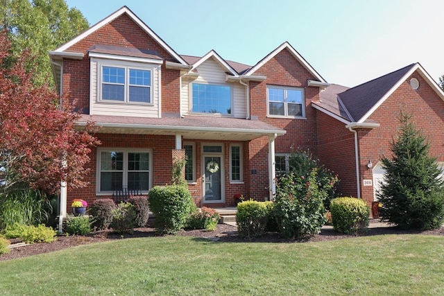 craftsman house with brick siding and a front yard