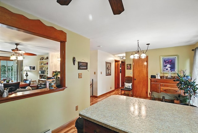 155 W Smiley Ave, Shelby, OH 44875 - kitchen featuring ceiling fan, wood finished floors, hanging light fixtures, and open floor plan