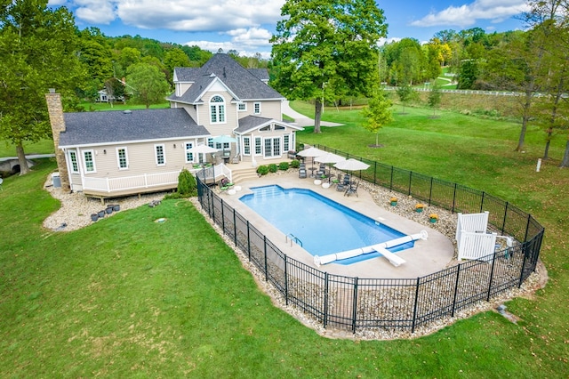 view of pool with a patio area, a diving board, and a yard