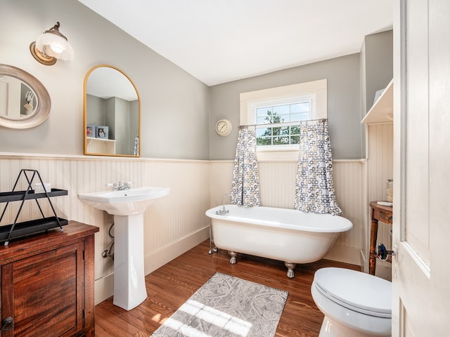 bathroom with sink, hardwood / wood-style floors, a bathtub, and toilet