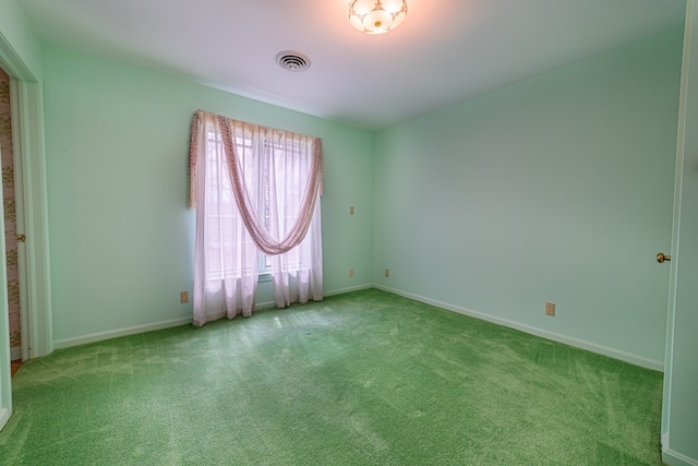 unfurnished room featuring light carpet