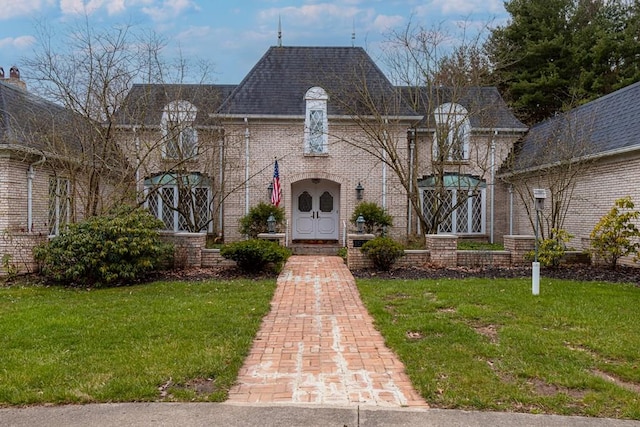 french country home featuring a front lawn