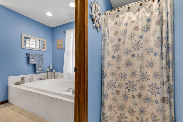 bathroom with visible vents, curtained shower, and a bath