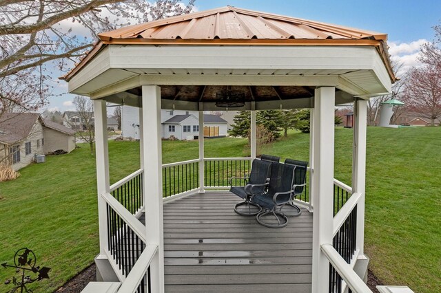 wooden terrace featuring a gazebo and a yard
